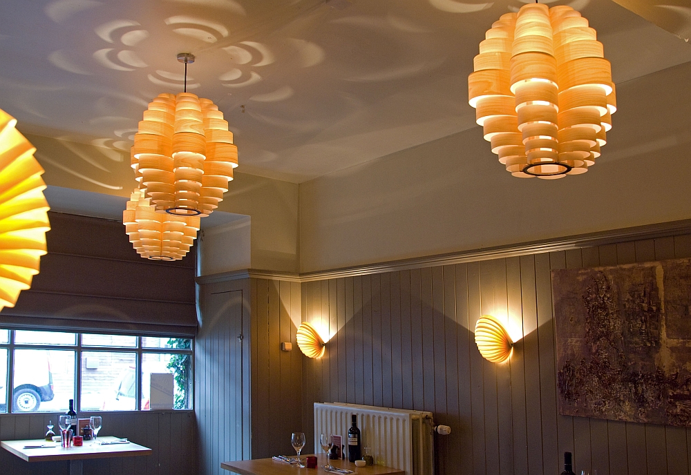 Passion 4 Wood - Glow and Nautilus lighting in toulip wood veneer the small room of this restaurant